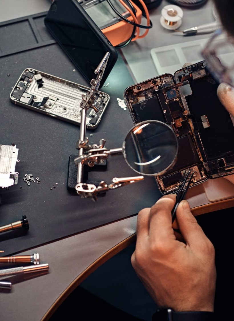 technician-carefully-inspect-the-internal-parts-of-the-smartphone-in-a-modern-repair-shop.jpg
